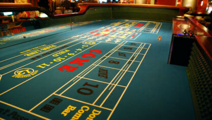 Playing craps one of these tables.